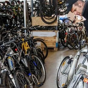 Reperatør i sykkelverksted undersøker sykkel